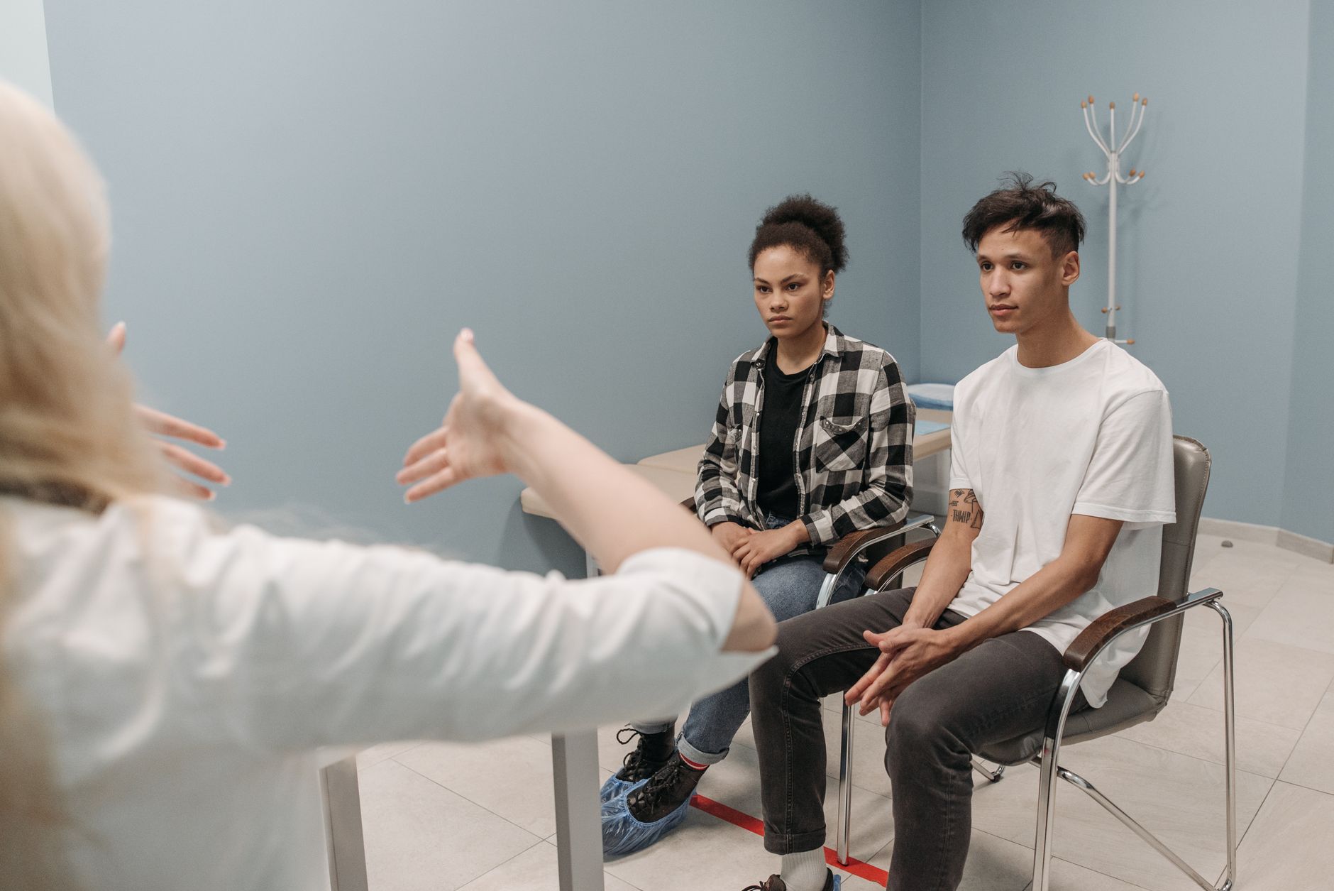 A couple engaging in a conversation during a therapy session indoors.