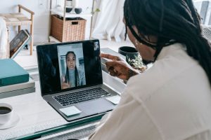 Angry African American couple having video call via modern netbook and arguing in misunderstanding