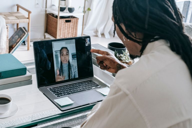 Angry African American couple having video call via modern netbook and arguing in misunderstanding